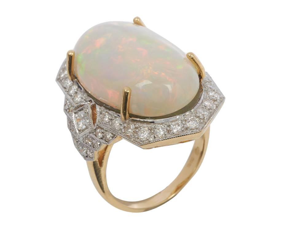 Add some Vintage style Red Carpet glamour to your loved ones life, with this extraordinary cocktail ring. Weighing an impressive 16.03g, the central oval cabochon opal displays an illustrious play of colour, including pinks, blues and greens. A