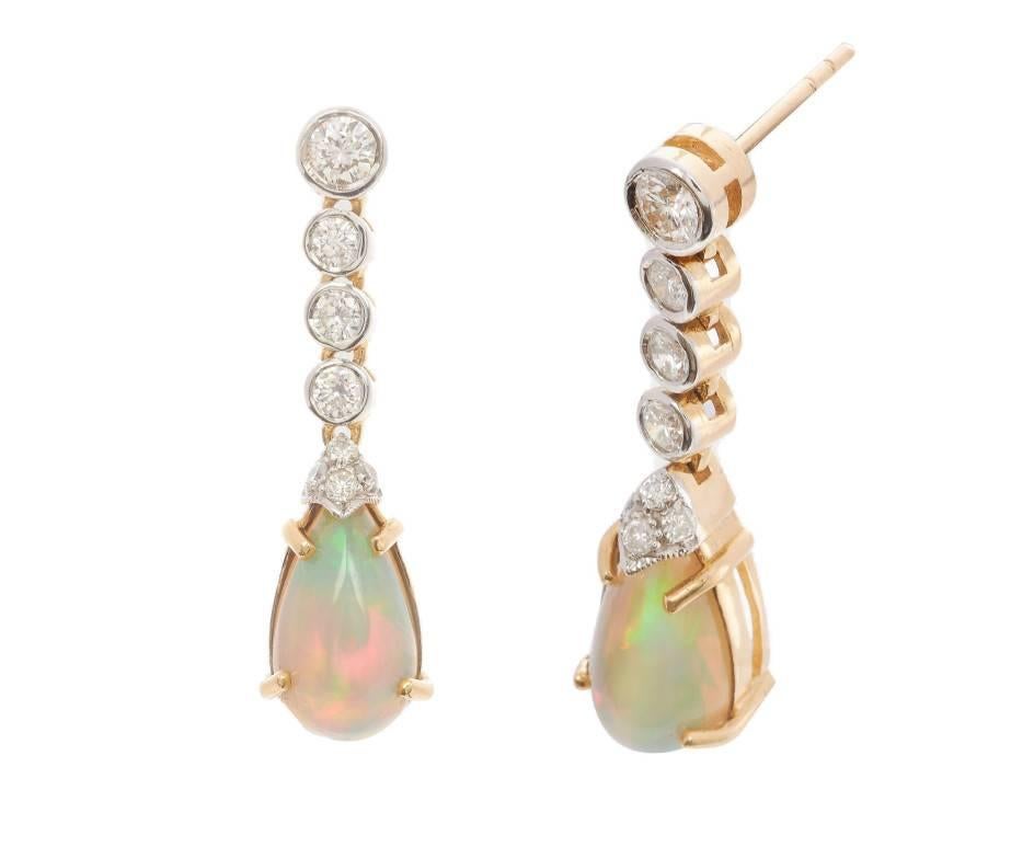 A most delightful pair of opal drop earrings crafted from 18ct white gold with gorgeous iridescent pear drop opals (4.00ct approx) suspended from sparkling strands of scintillating diamonds (0.96ct approx). Elegant, opulent and divine with a