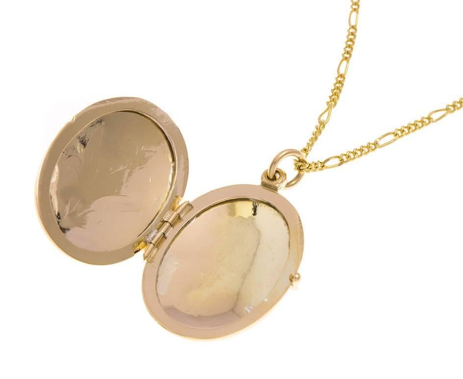 Fashioned in gold this lovely locket is engraved with a delicate floral motif and suspended from a 28
