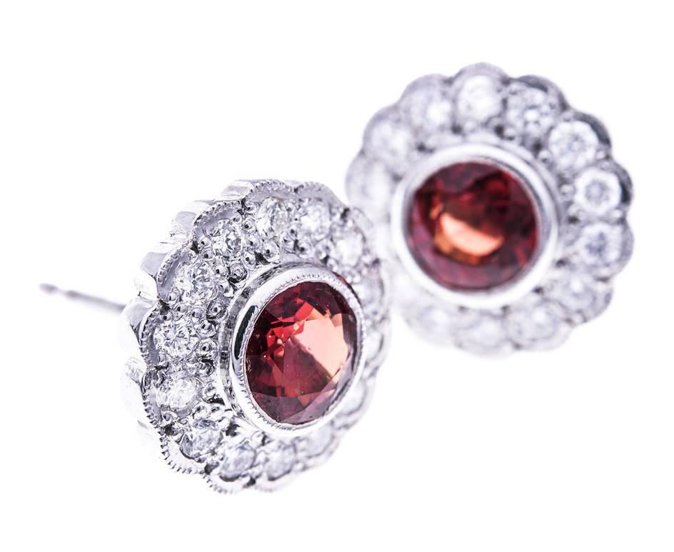 Fabulous round faceted bright orange sapphires framed with beautiful sparkling diamonds in a delicious floral cluster design. These gorgeous British made cluster earrings will make a lovely gift for a sapphire occasion or a September birthday.
