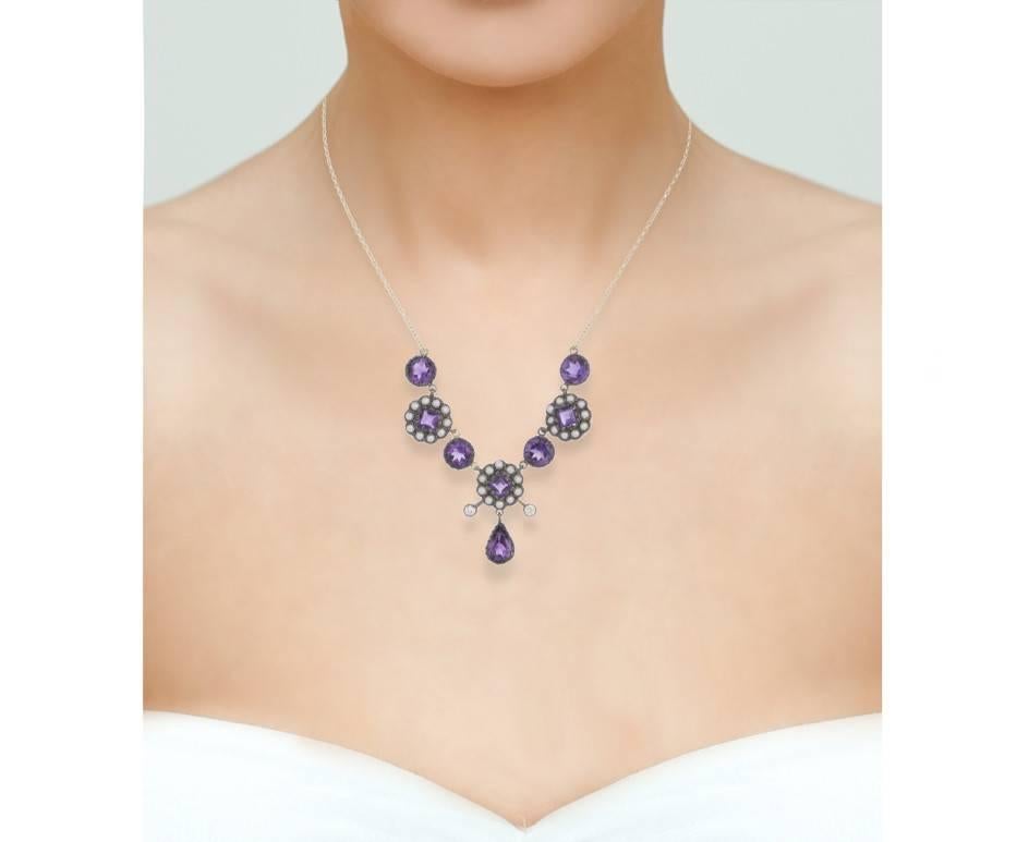 An Edwardian style floral necklet set with lovely bright amethyst. Pearl seed flowers and diamond set tendrils add to this darling piece. Completed with a 9ct gold trace chain. Wear as a short collar or a longer necklace by adjusting the length of