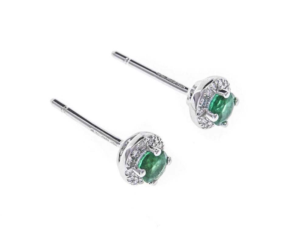 These delicate and pretty 18ct white gold studs are set with vibrant green emeralds and are framed in a halo of dazzling diamonds. They are elegant and beautiful and are the perfect jewels for everyday glamour. A great gift for a May birthday or an