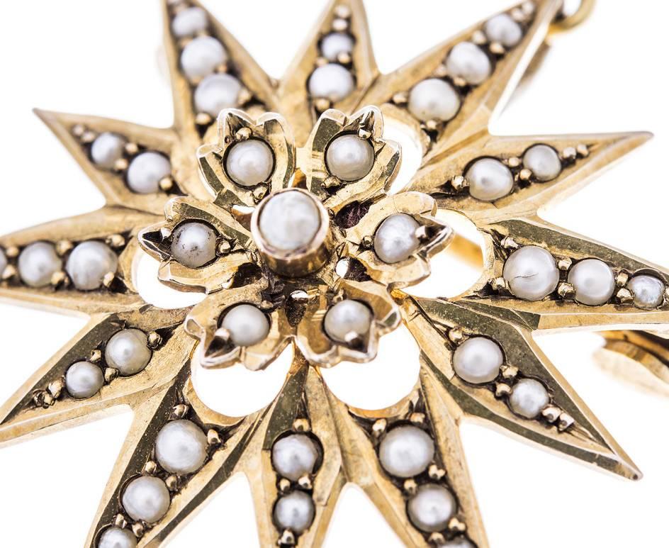 This beautiful example of early 20th century jewellery. The lovely split pearl cluster, centred within a 12 ray shimmering split pearl star. 

A lovely piece that can be worn as pendant or a brooch. The perfect piece for a vintage inspired wedding.