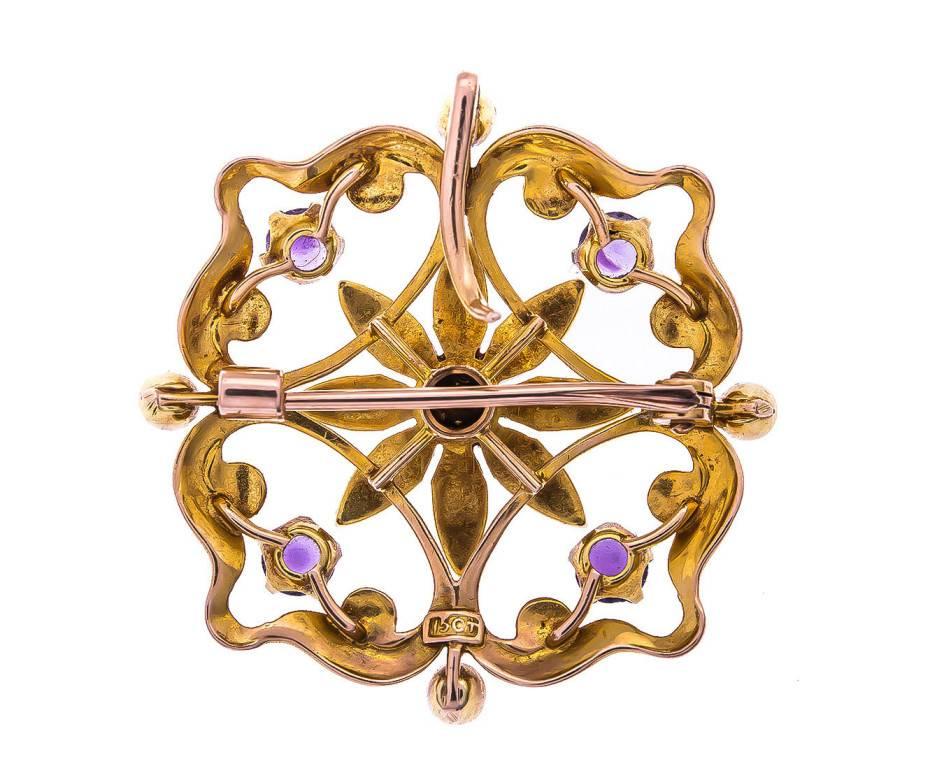 GEMMOLOGIST'S NOTES
 This glorious early 20th century pendant. The luxurious seed pearl flower, within an openwork scrolling surround embellished by amethyst highlights.

An impressive but feminine piece, that can also be modelled as a brooch.

The