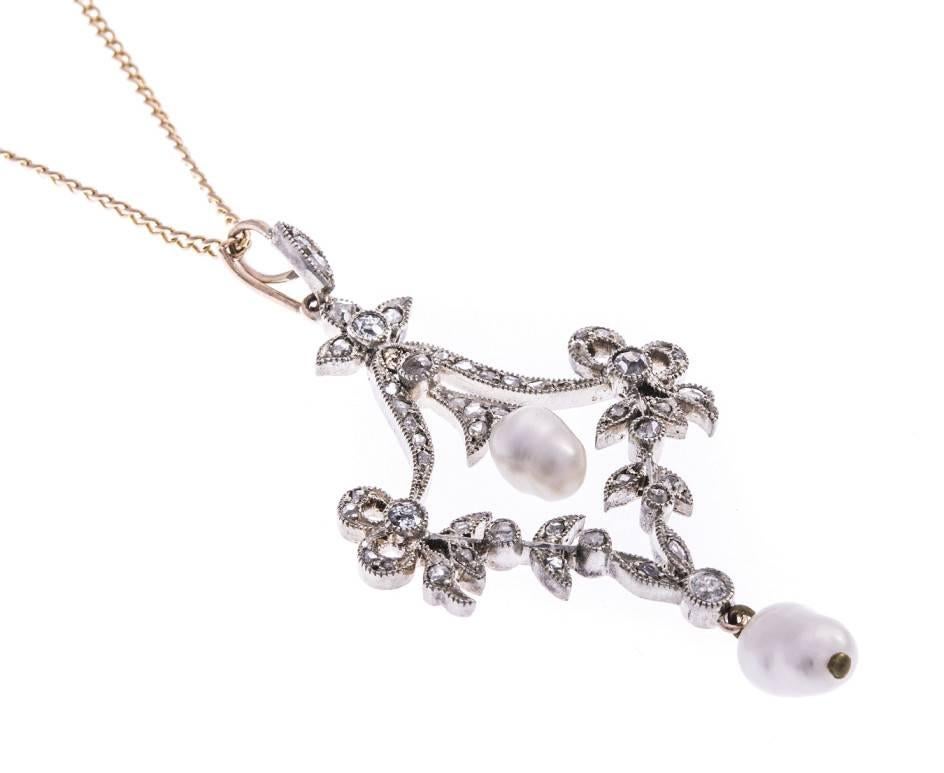 This Victorian inspired pendant, the stylish curved and foliate decoration, embellished with twinkling diamonds, and statement luxurious pearl drops.

A beautiful piece, with a hint of elegance and filled with sparkle. 

Any bride would love this a