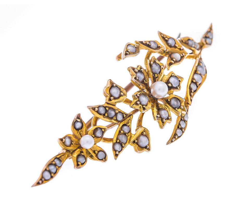 GEMMOLOGIST'S NOTES
This beautiful brooch, that has been handcrafted during the early 20th century, designed as a flower, set throughout with a section of shimmering split pearls. 

A gorgeous piece, that would be the perfect accessory for the