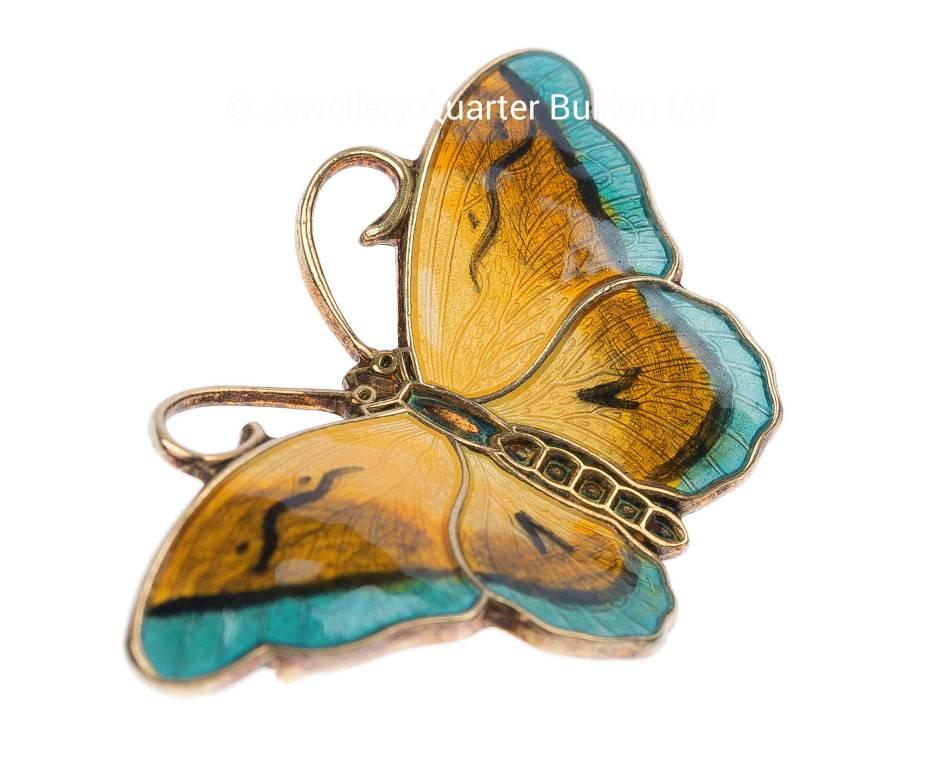 GEMMOLOGIST'S NOTES
A stunning example of Norwegian artistry from the renowned designer Hroar Prydz. Having being crafted before the 1950 buy out, this beautiful jewel exhibits fabulous shadings of yellow to brownish-orange and sky blue. A symbol of