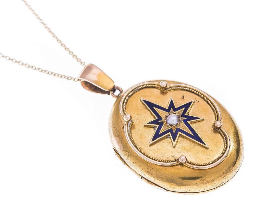 A beautifully crafted Victorian locket.

One side models a split pearl, within a blue enamel star and cannetille detail, the other side displays pretty ornate enamelled engraving. 

Opening to reveal two spaces for a special memento, makes this a