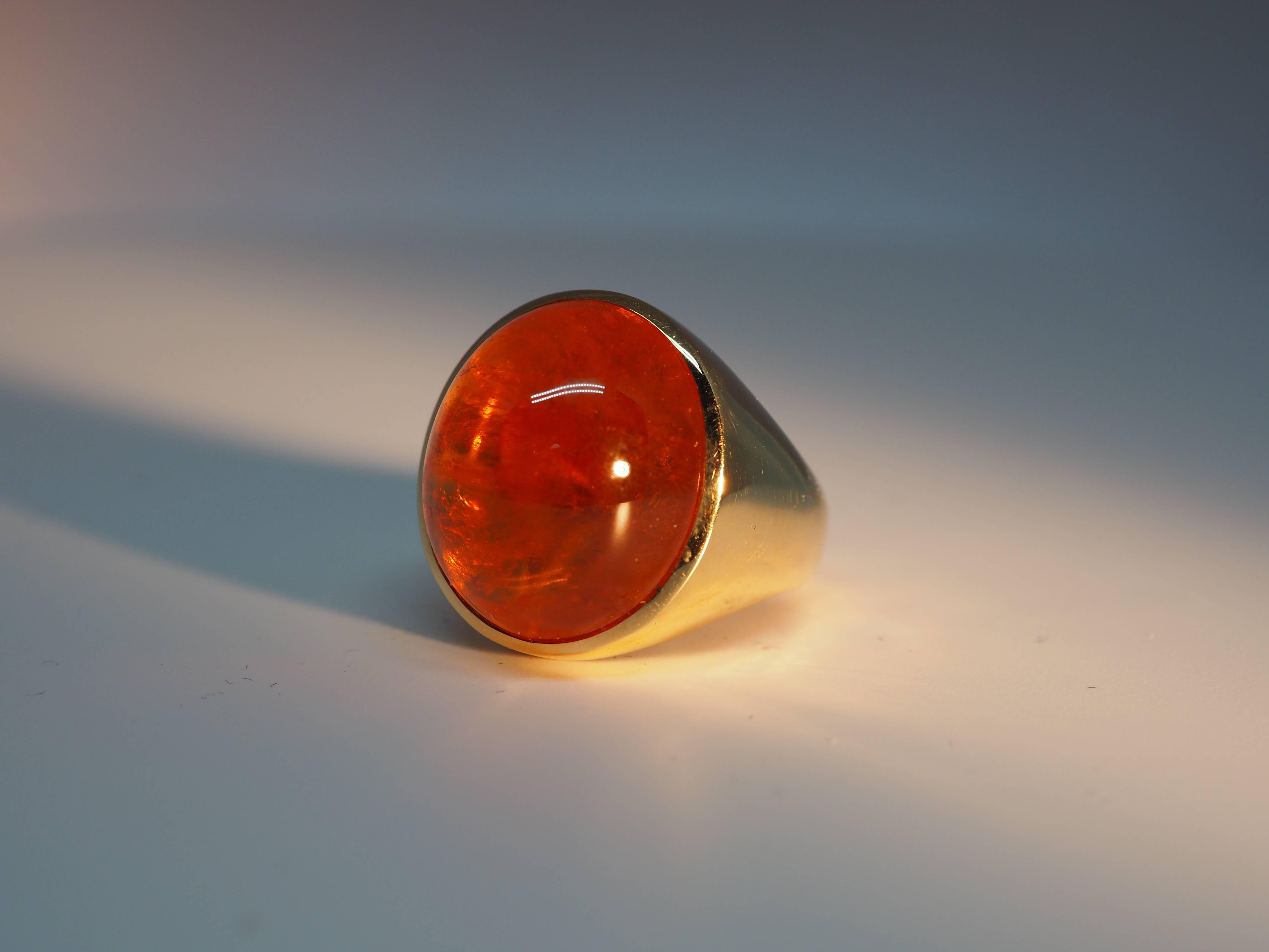 Thomas Leyser is renowned for his contemporary jewellery designs utilizing fine coloured gemstones. 

This ring in 18k rose gold is set with a beautiful Mandarin Garnet Cabouchon with a weight of 28.50ct in oval shape (20x18mm).

Ringsize 7.25 
