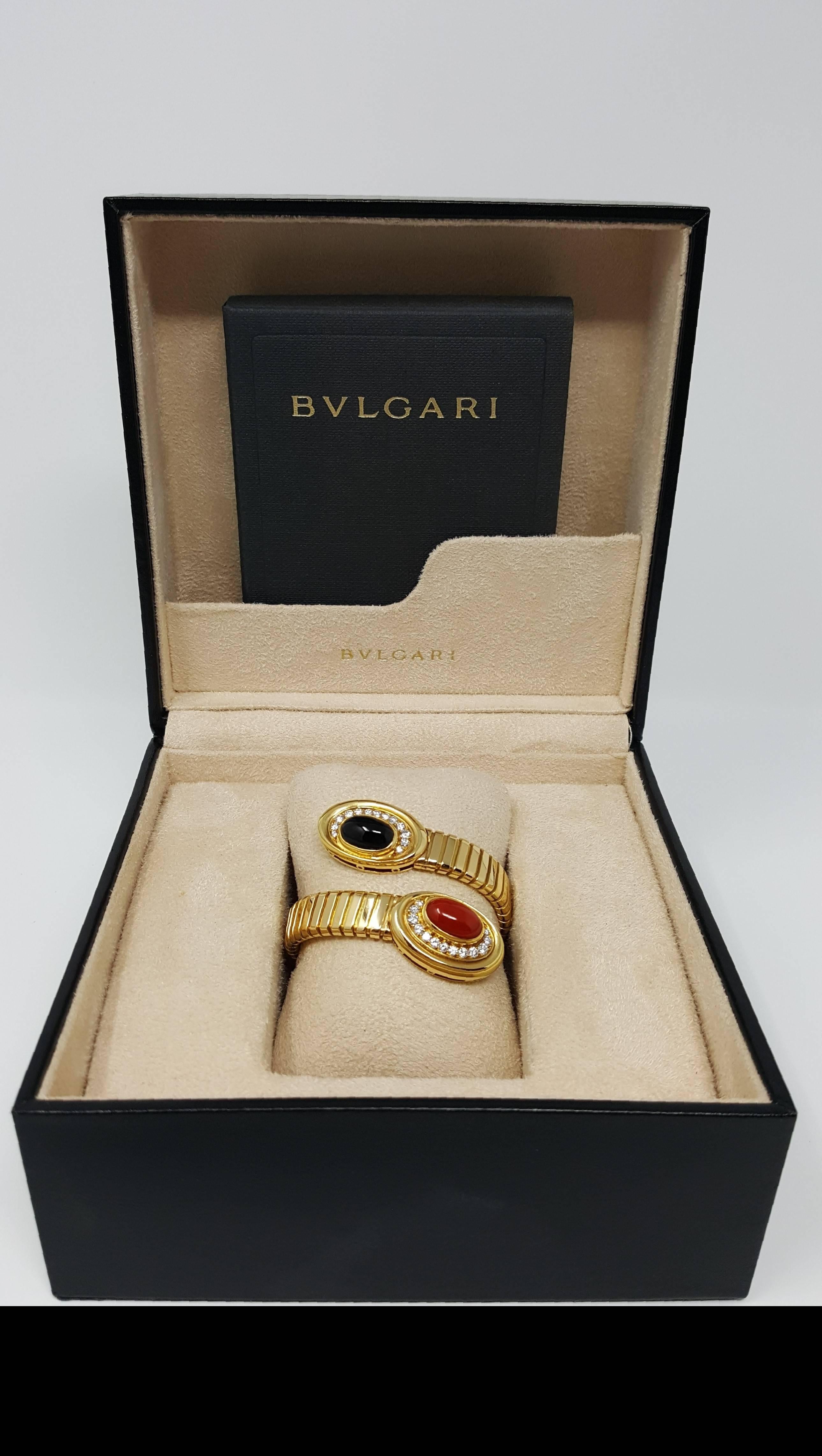 Gorgeous vintage 18 karat Bvlgari Tubogas Serpentine Bracelet with beautifully bezel set oval cabachon cut coral, onyx and surrounded by brilliant white diamonds.