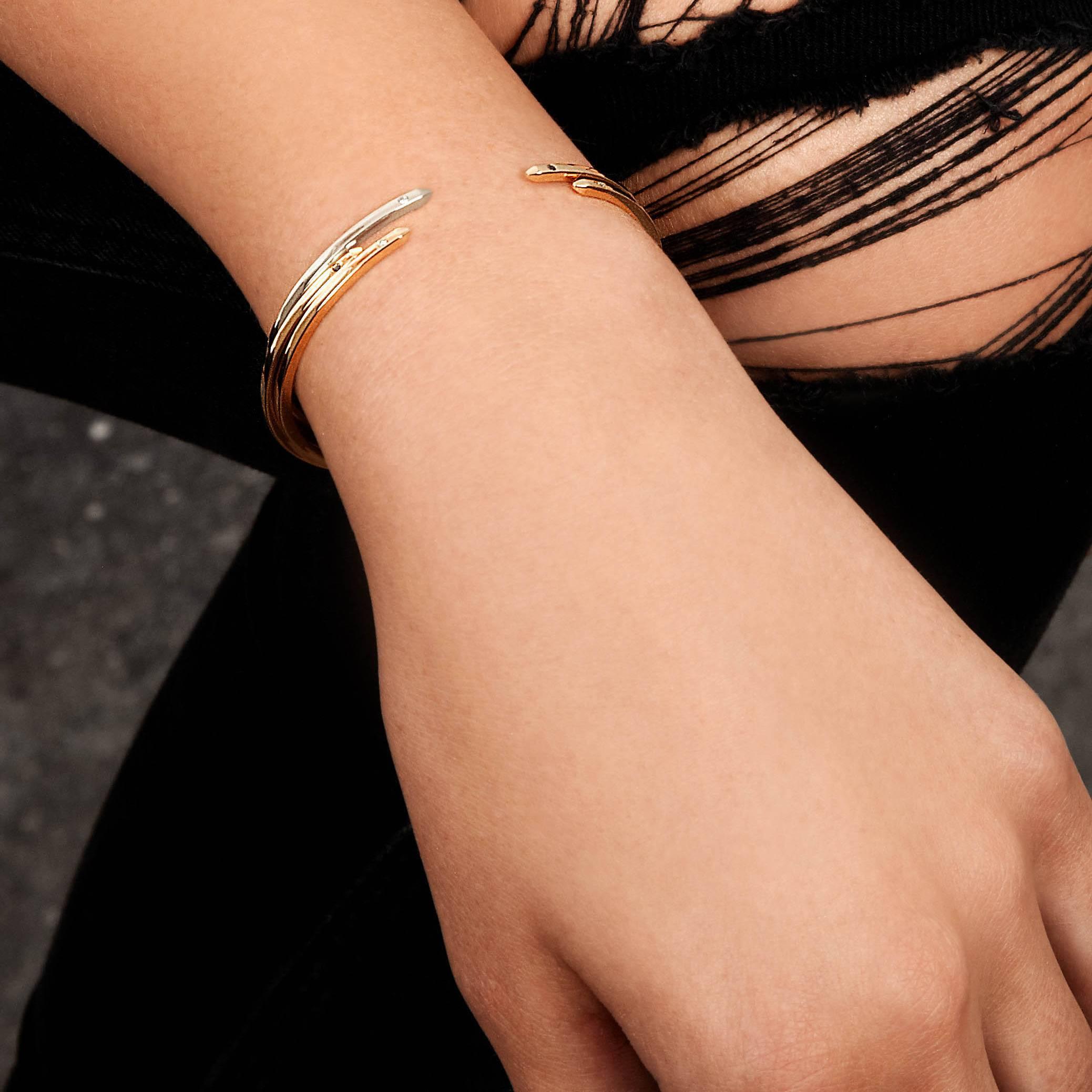 An elevated take on a jewellery basic, our 2mm-square cuff in 9-carat yellow gold has square beveled edges and two black diamonds.  Total diamond carat weight .016 carats.  The bracelet is slightly flexible to enable a customised fit for the