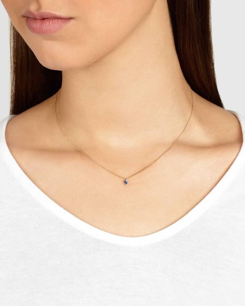 This necklace features a delicate faceted blue sapphire briolette strung on a fine 16-inch chain.  The 9-carat yellow gold chain is hallmarked and total sapphire carat weight is approximately 0.2 carat. 

Handmade in London. Hallmarked 375. 