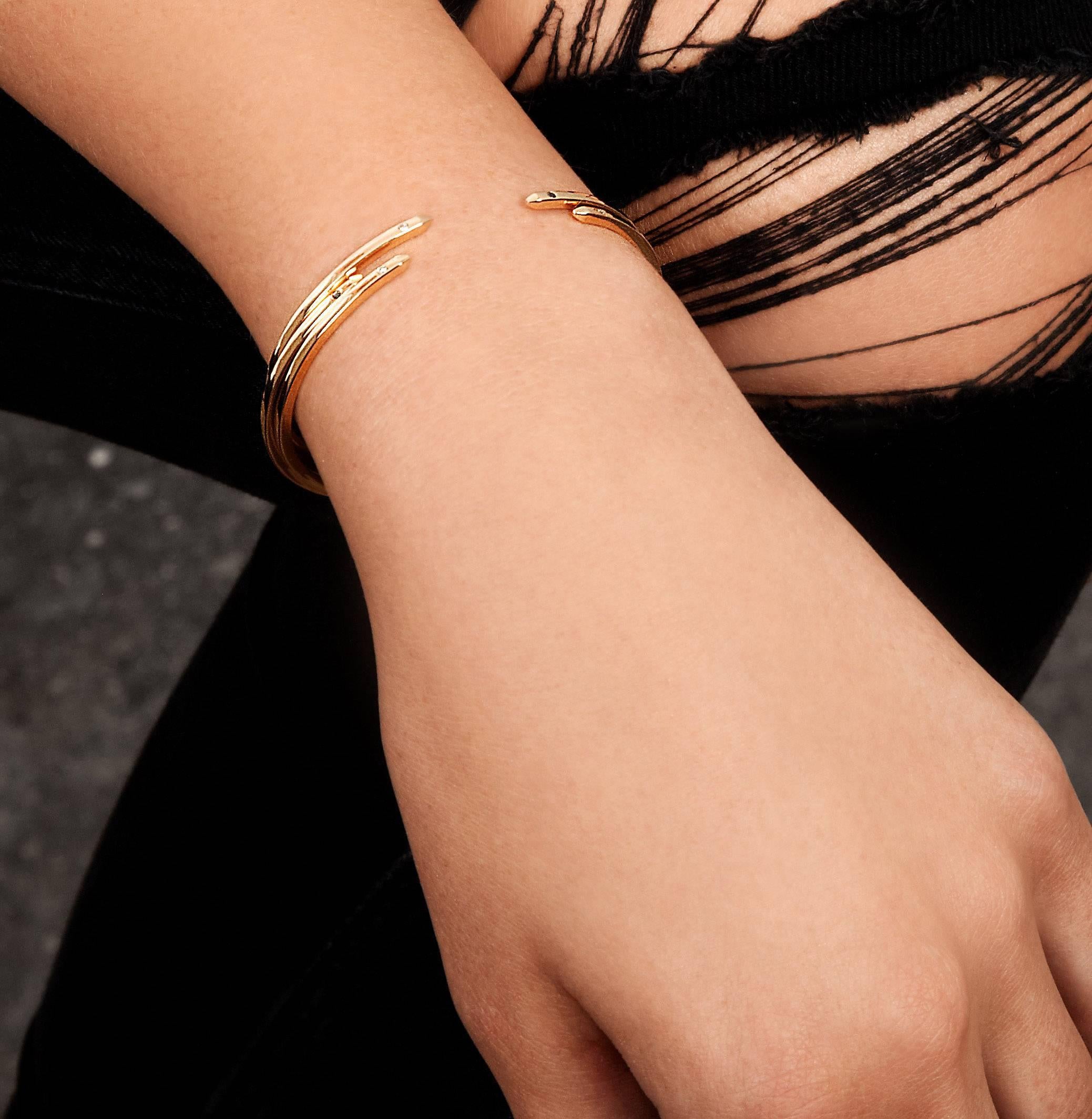 An elevated take on a jewellery basic, our 2mm-square cuff in 18-carat yellow gold has square beveled edges and two white diamonds.  Total diamond carat weight .016 carats.  The bracelet is slightly flexible to enable a customised fit for the