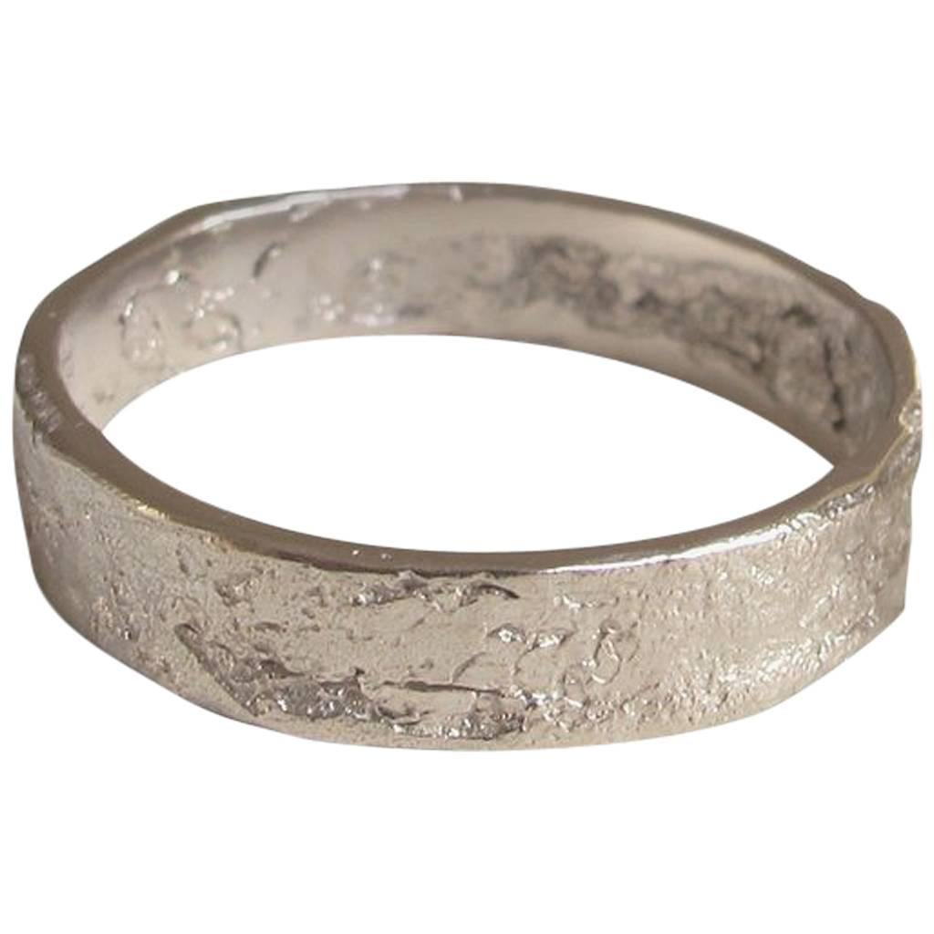 Solid 18-carat white gold textured ring, approximately 5mm wide.  

Every piece in Allison Bryan's Paper collection is individually hand-crafted in paper and cast directly into precious metal in a unique and innovative process.  Every piece