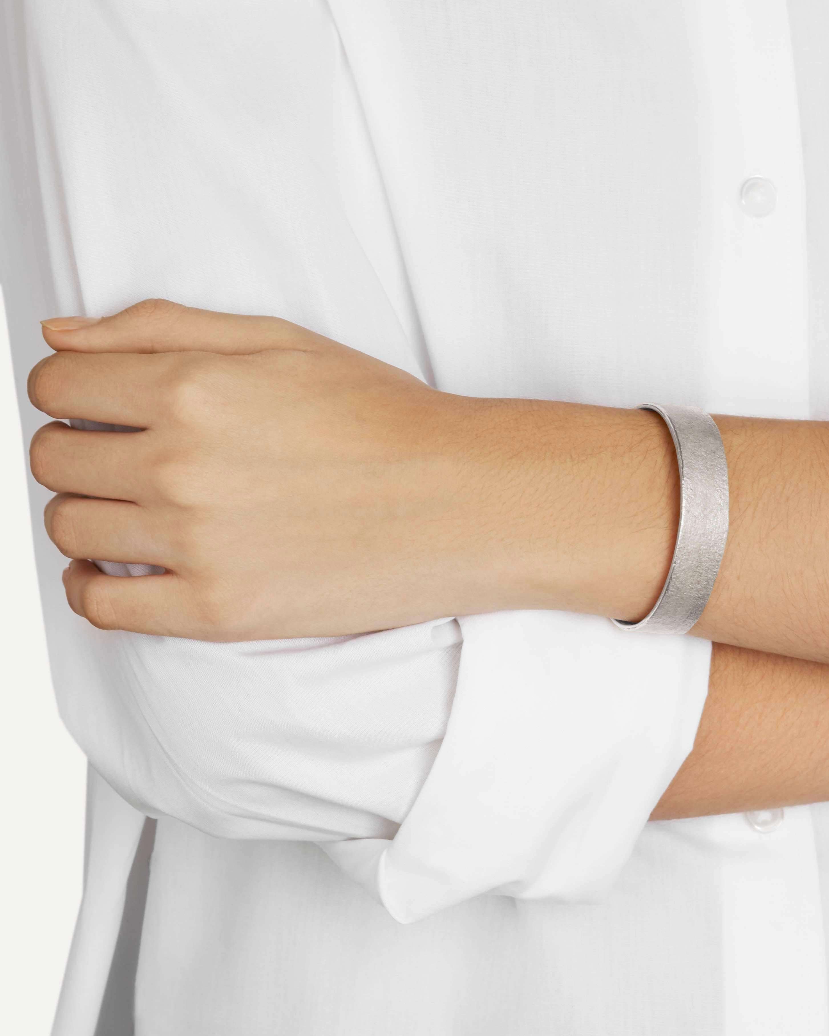 This clean-lined cuff bracelet features a rustic texture in heavy, shimmering solid sterling silver.  Every piece in this collection is individually hand-crafted in paper and cast directly into precious metal in a unique and innovative process.