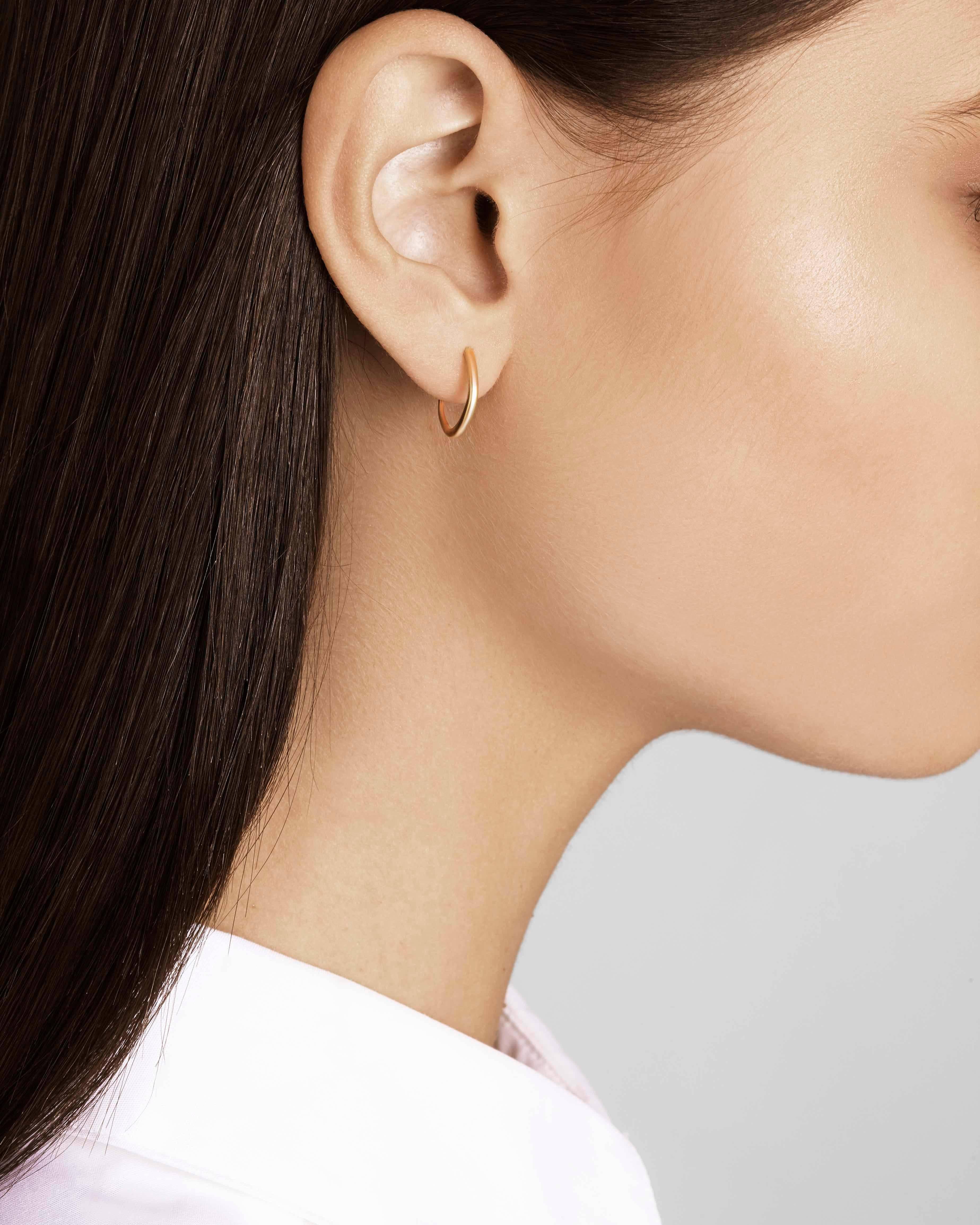 These delicate hoop earrings are crafted in solid 18-carat gold with a post and butterfly closure.  Modelled after traditional Touareg jewellery, these earrings are a bohemian take on the classic gold hoop.  These earrings are made to order; please
