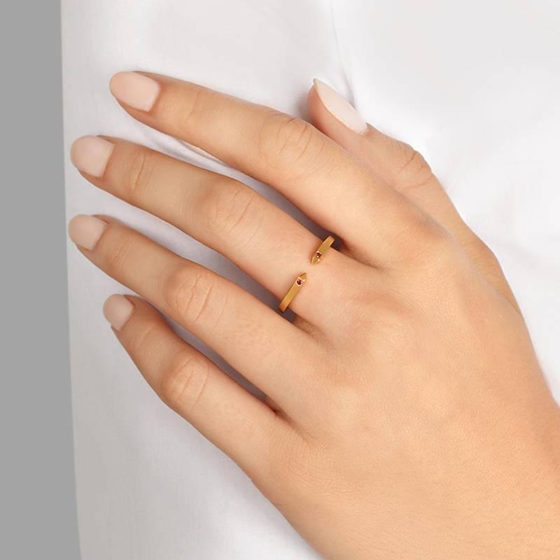 Understated yet edgy, this open ring in 9-carat yellow gold is accented with two sparkling rubies. Equally at home alone on the finger or stacked with other gold bands.  In stock in UK size N (US size 6 1/2) and UK size O (US size 7).

Handmade in