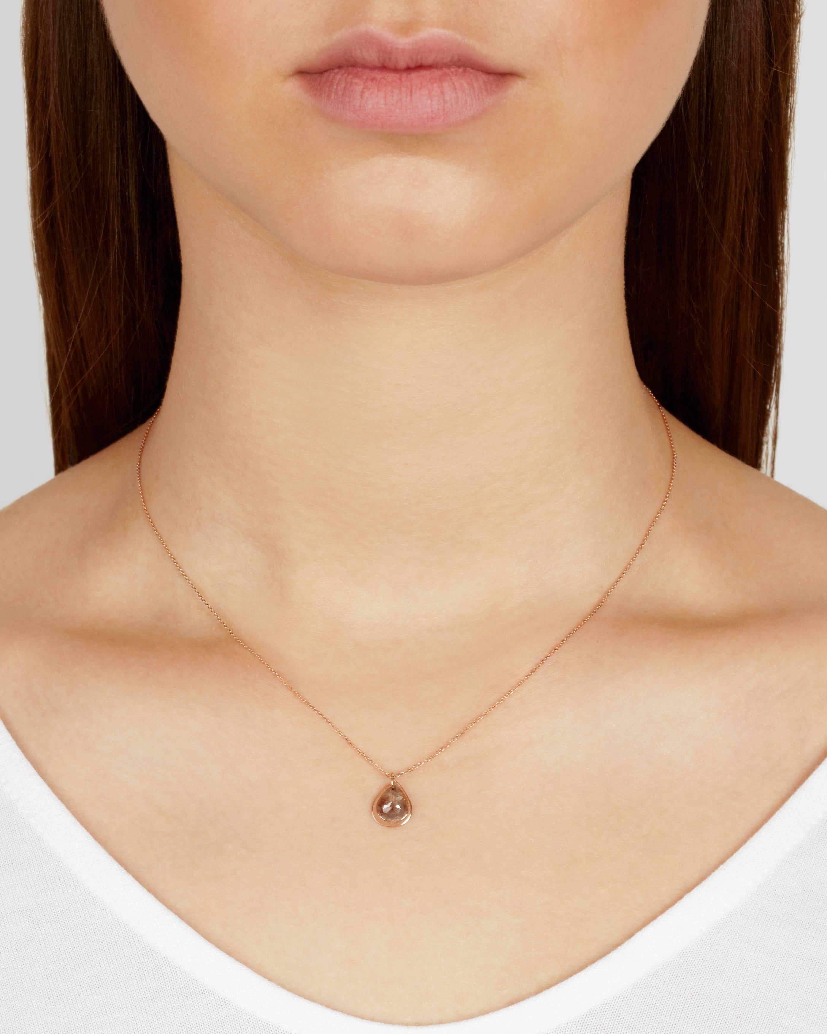 Lightweight and easy to wear, this necklace features a solid 9-carat rose gold teardrop accentuated with a rough rosecut diamond of over a carat in weight. The two elements hang independently from a delicate 16inch 9-carat rose gold chain which