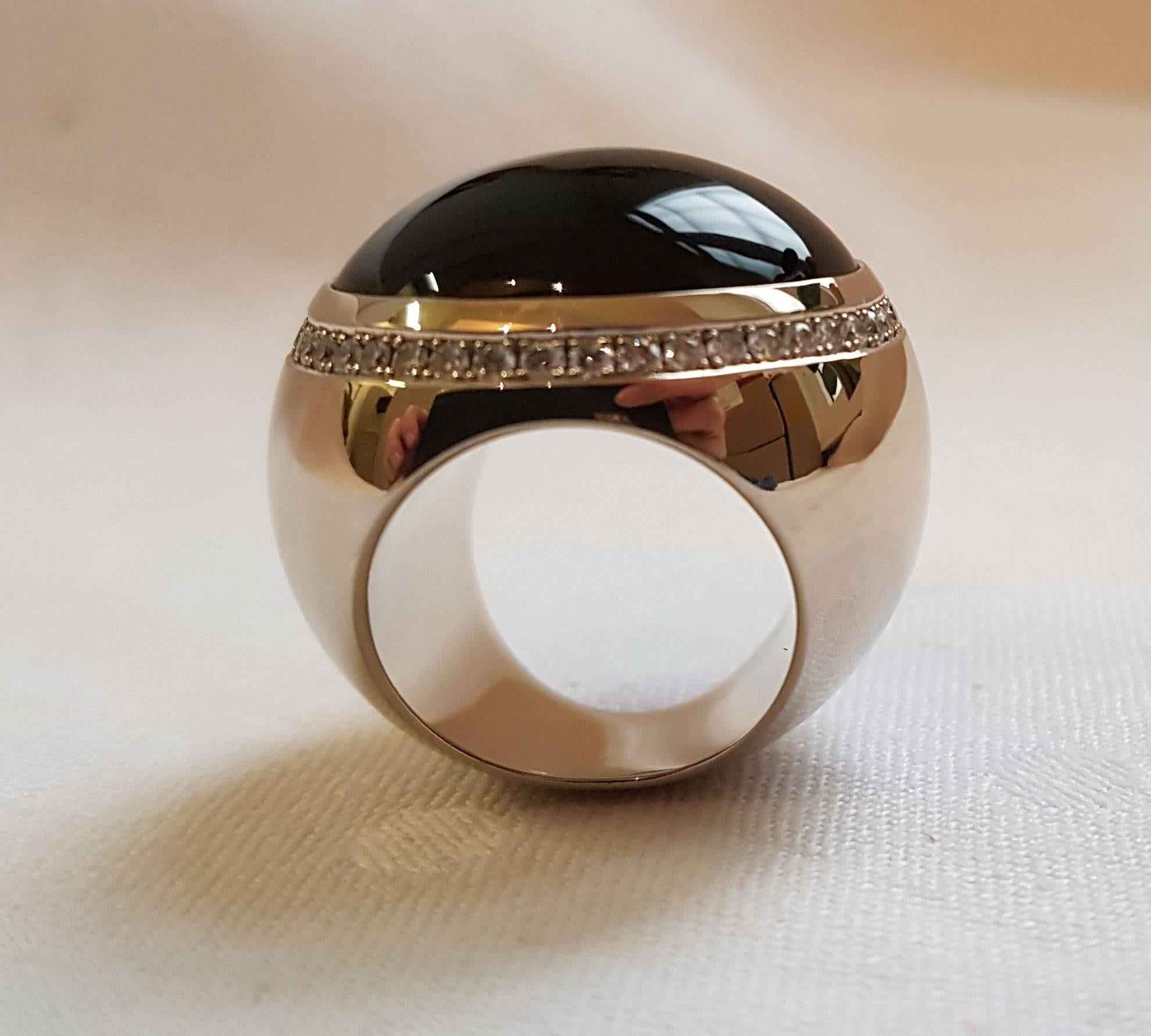 Extravagant design ring made by Wagner Preziosen.
18 carat white gold, onyx cabochon surrounded by 44 diamonds 0.88 carats.
Ring size: 53 (European Size).
A flashy ring for outgoing personalities.