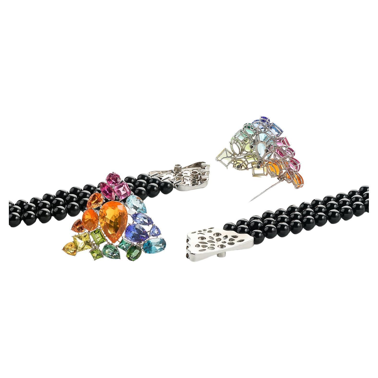 Exquisite materials combined with outstanding craftmanship is the essence of this spectacular piece of jewelry in the colors of the rainbow, centered on three rows of onyx pearls. Each stone has its own setting, mounted at different angles, so every