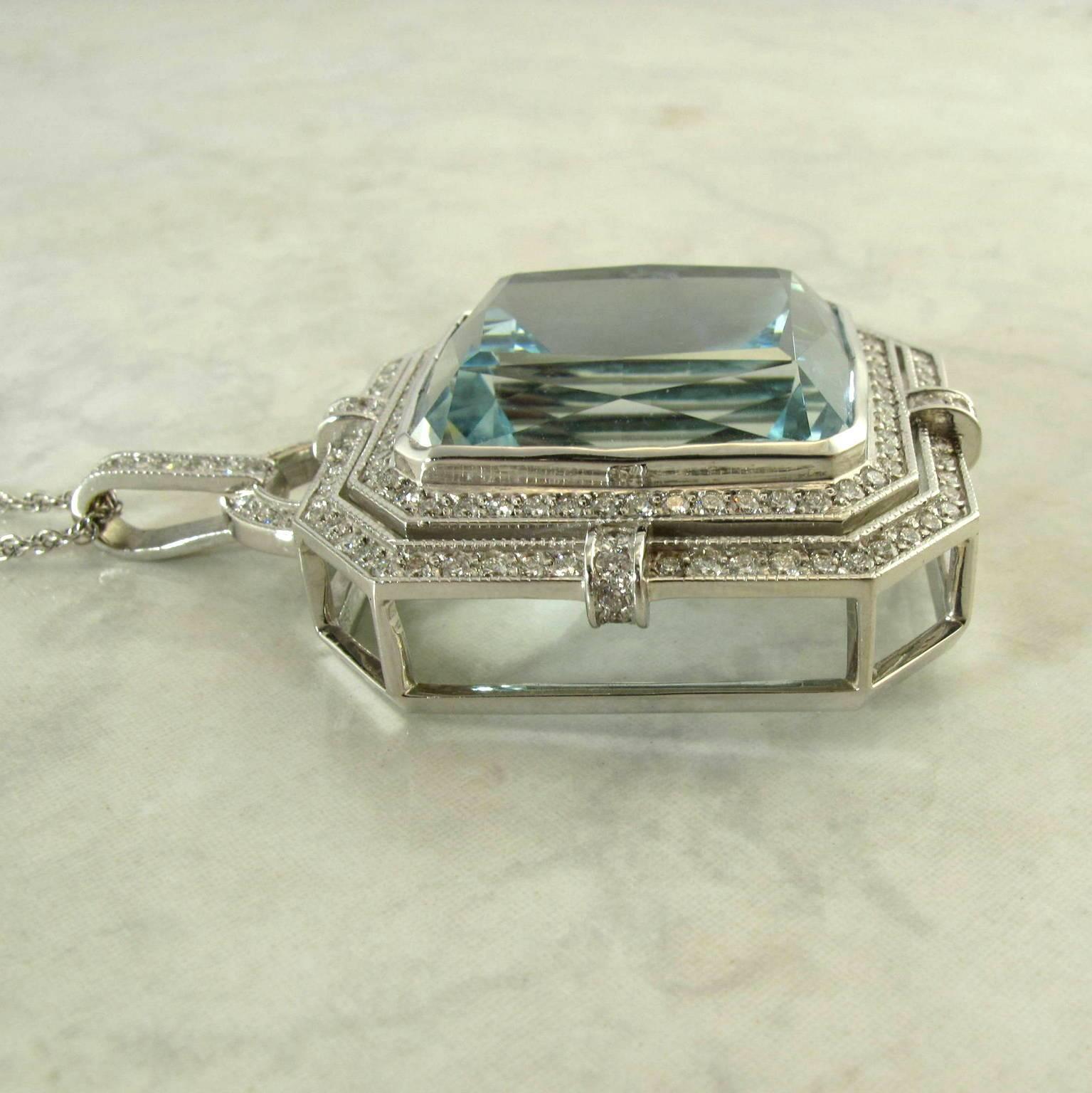 18 karat white gold aquamarine and diamond pendant necklace.
The handcrafted setting with one center cushion cut aquamarine weighing 57.00 carats, cut by Mark Kaufman, most awarded lapidary in the world, including the Cutting Edge award. The
