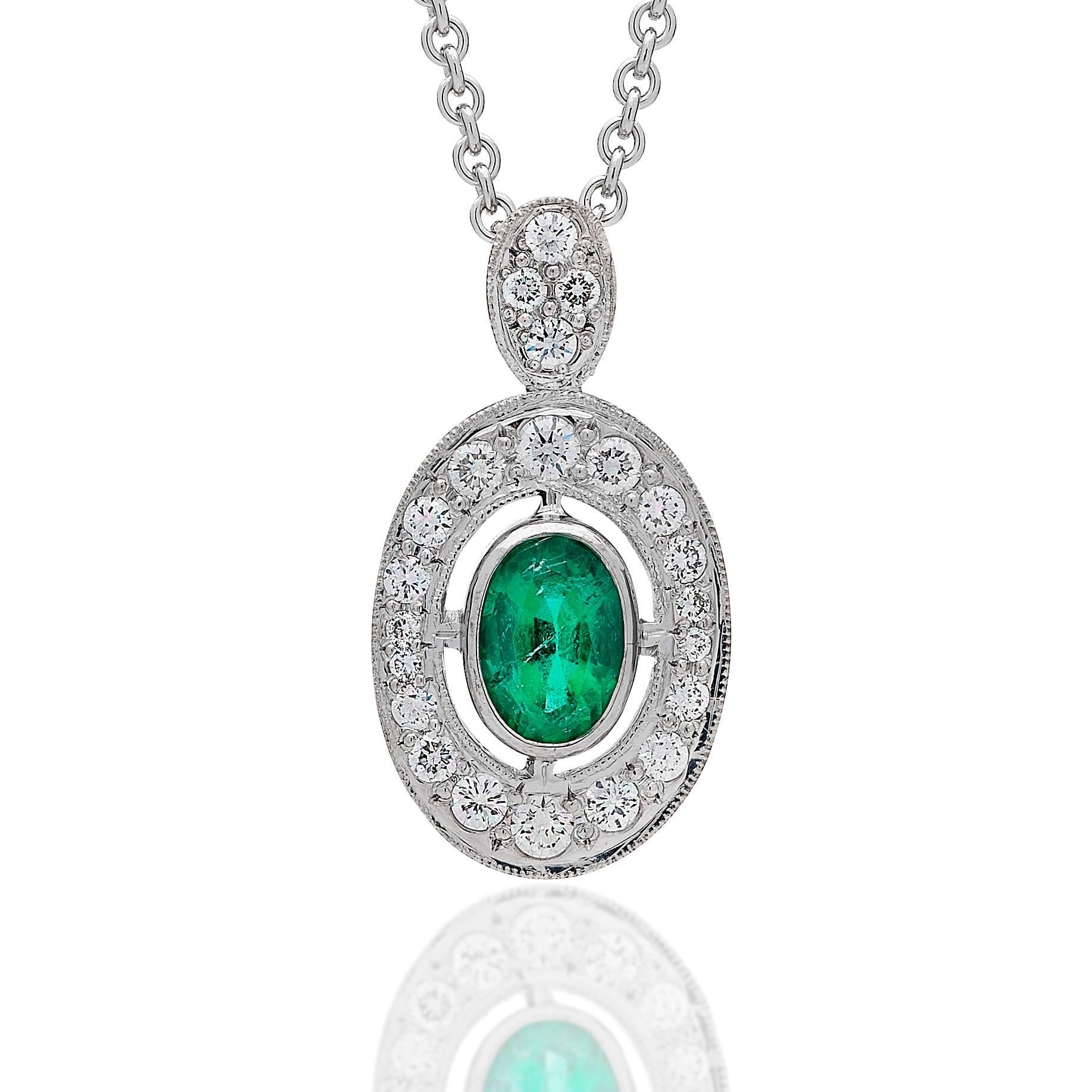 Handmade 18kt white gold 'Halo' style pendant centred with a 0.62ct oval Columbian emerald of bright green colour, fine pique.  Surrounded by 0.35cts of brilliant cut diamonds G/H Si1.

*Excludes Chain - Pendant Only*

