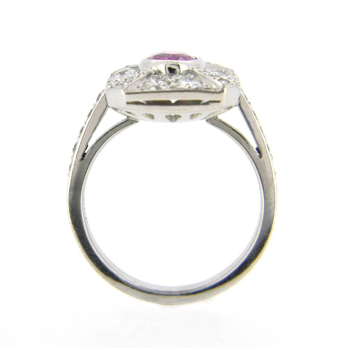 Handmade 18 karat white gold pink sapphire and diamond Art Deco style ring centred with a vibrant oval cut 1.58ct natural pink sapphire of a dark bright pink colour (slightly deeper pink than purple tone as photo shows)surrounded with 0.95cts of