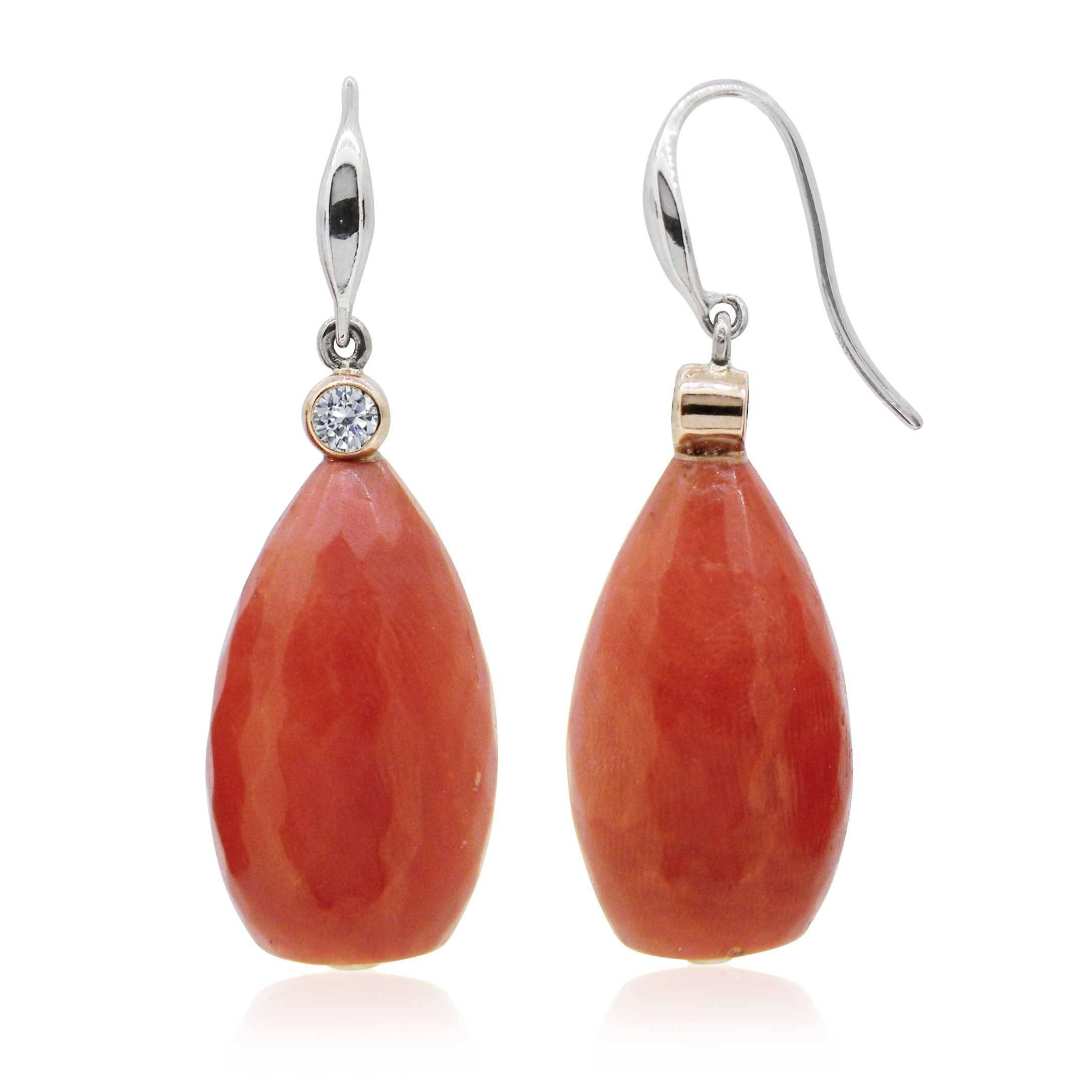 This beautiful pair of Antique coral bead earrings, with lovely subtlety faceting, has been remodelled with modern diamond-set fittings to give it a modern look.

Each earring measures approximately 23x13mm and features 1 x round brilliant cut