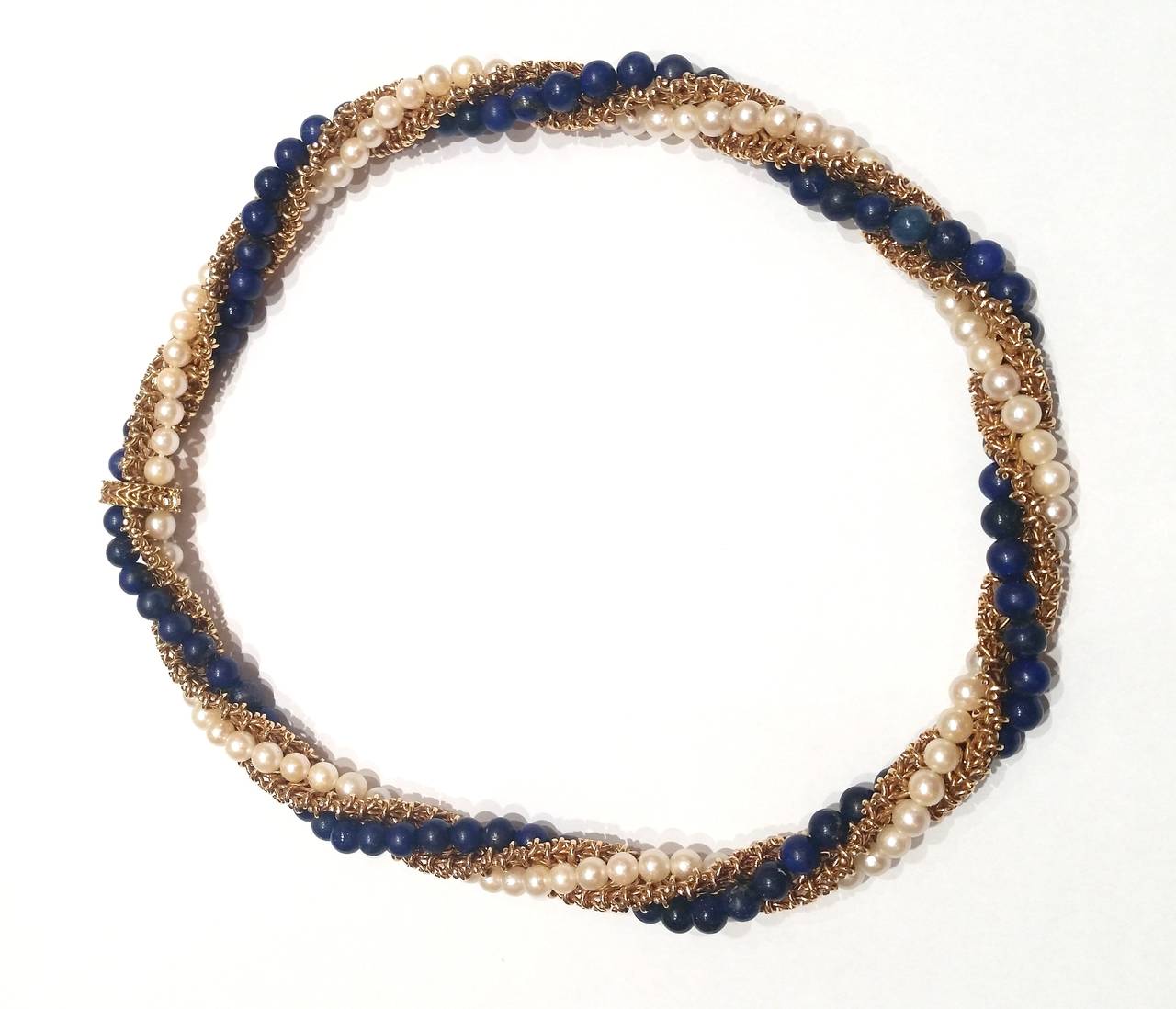 Bracelet and necklace, wearable as a long necklace
18k yellow gold beaded mesh design wrapped in strands of lapis beads and cultured pearl
French assay marks

Necklace 41cm
Bracelet 20cm