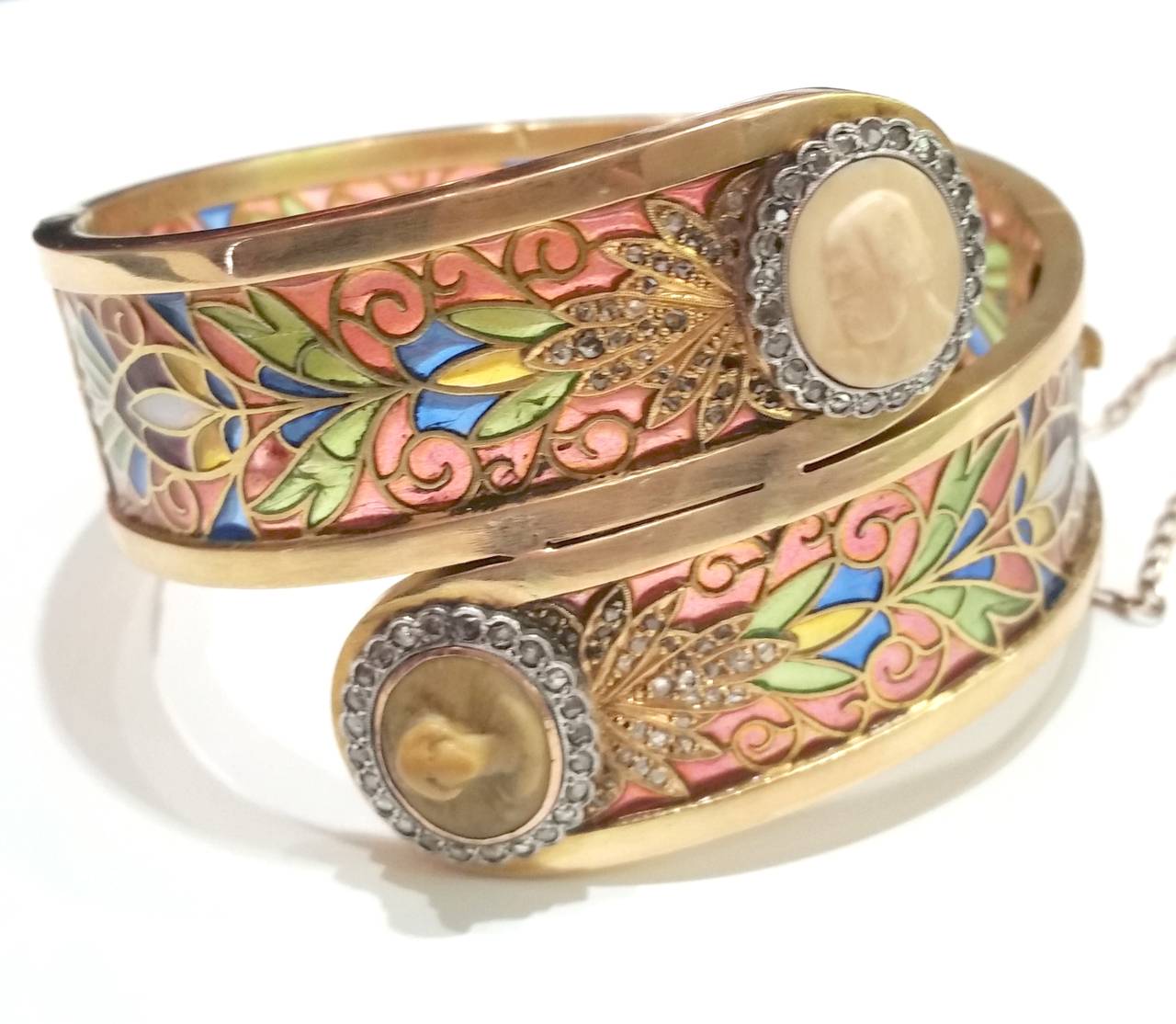 Art Nouveau bangle bracelet, made of yellow gold and platinum, with plique-a-jour multicoloured enamel depicting vegetal motifs.
On the ends, two diamond cluster with cameos.
Signed Masriera y Carreras

Rose cut diamonds, total weight 0.50ct