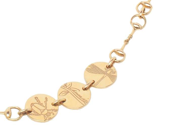 GUCCI 18K Yellow Gold Necklace from the Flora Collection. Stirrup Style Chain with seven medallions depicting various insects and butterflies.

With Original Jewellery Bag and Case. Signed Gucci and Made in Italy.