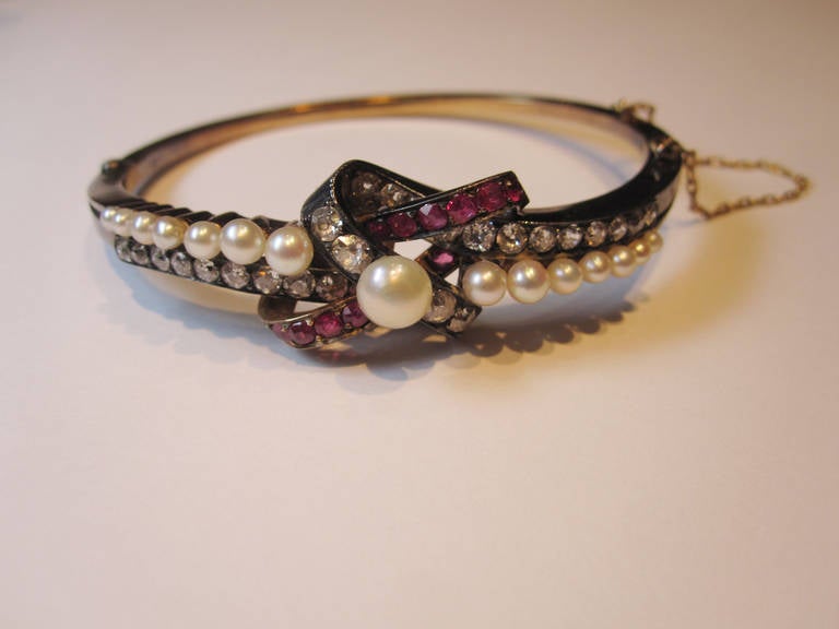 19th Century bangle in gold and silver with 15 pearls, 12 round cut rubies and 28 antique brilliant cut diamonds approx. weight 2.5ct.