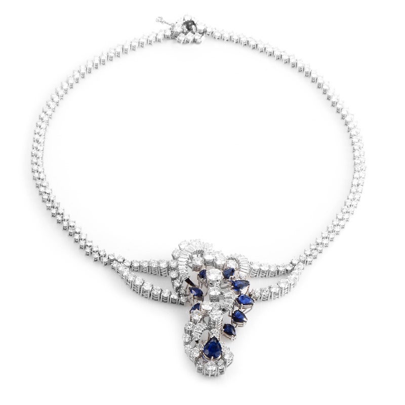 Elaborately designed and breathtakingly beautiful, this decadent collar necklace is sure to garner much attention. The necklace is made of 18K white gold and is set with ~30.81ct of plush white diamonds as well as ~5.50ct of sapphires.