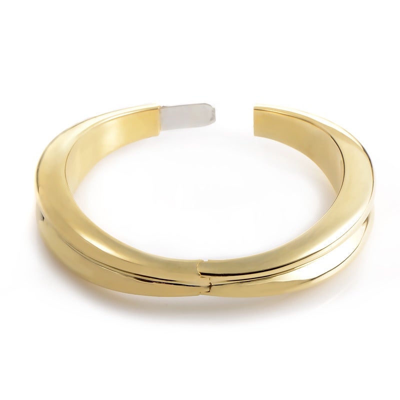 This bangle bracelet from Tiffany & Co. has a fairly simple design that is still very distinguished. The bracelet is made of 18K yellow gold and is rather thick for a bangle bracelet; the perfect statement piece.