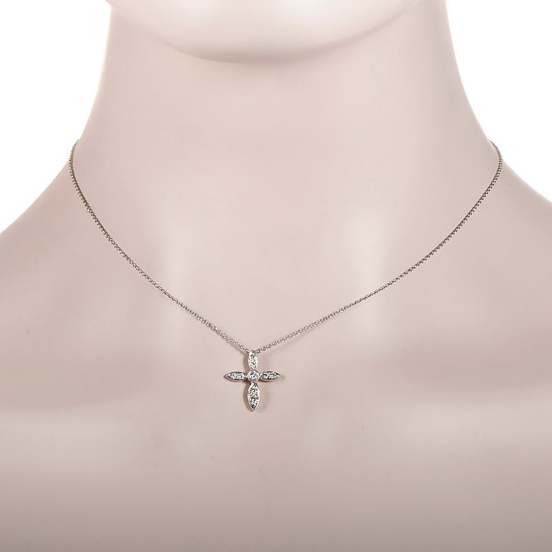 Simple and sweet, this tastefully elegant pendant necklace from Tiffany & Co. will add a hint of sparkle to any look. The necklace is made of platinum and boasts a petite cross-shaped pendant set with ~.43ct of diamonds.
Approximate Dimensions: