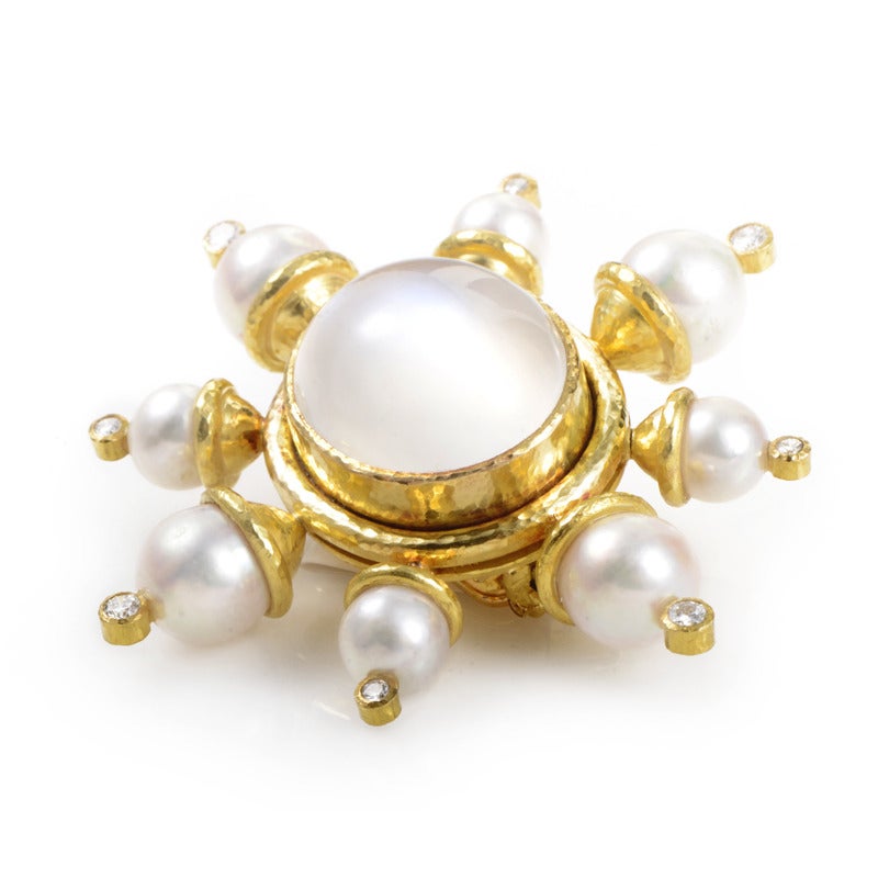 Ethereal white stones add a luxurious glow to this lavish Elizabeth Locke brooch. The brooch is made of 18K yellow gold and boasts a milky white moonstone main stone. Lastly, eight pearls and diamonds poke from the sides of this brilliant