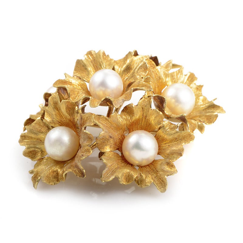 Artfully crafted blooms comprise the bold design of this Buccellati brooch. The brooch is made of 18K yellow gold and is set with six round white pearls.