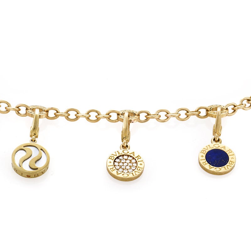 This charm bracelet made by Bulgari has a design that is adorable while remaining perfect for a lady of any age. The bracelet is made of 18K yellow gold and features five charms in the design. One charm is accented with mother of pearl, another with