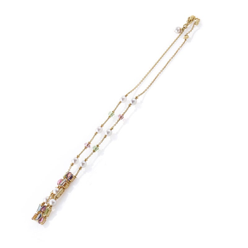Bulgari's Color collection embodies the brand's distinctive use of colored gemstones for a distinctive and playful elegance. This 3-row long pendant necklace is made of 18K yellow gold and boasts a pendant set with pink and green tourmaline,