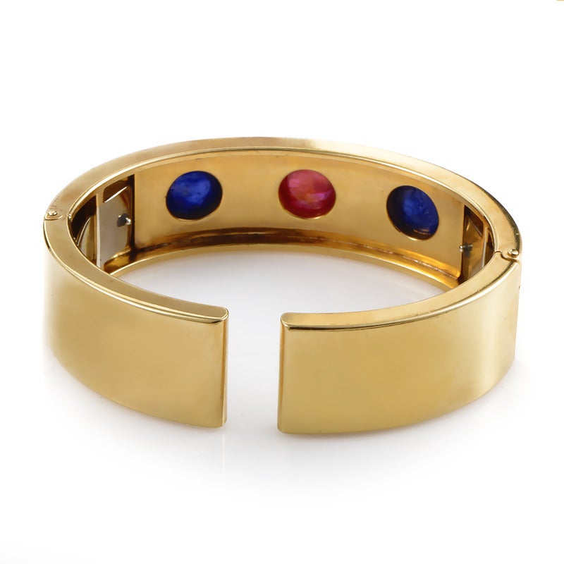 Bold and beautiful are the perfect words to describe the regal design of this bracelet from Bulgari. The bracelet is made of 18K yellow gold and is set with two sapphire cabochons and one ruby cabochon.