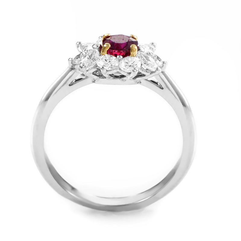 Brilliant and beautiful, this precious gemstone-set ring from Tiffany & Co. has a lavish design that is perfect for a sophisticated lady. The ring is made of platinum and features an ~.35ct ruby held in place by golden prongs. Lastly, a halo of