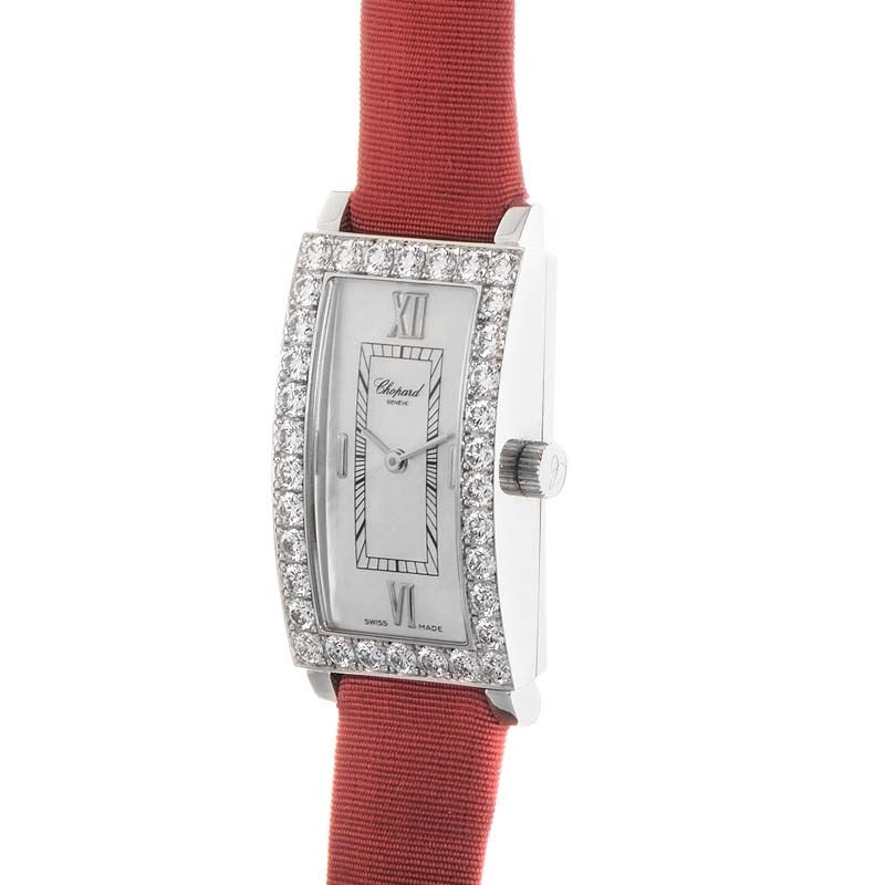 Chopard lady's 18K white gold quartz wristwatch with 34-diamond-set bezel on a red-fabric covered leather strap. Watch displays indication of hours and minutes on a mother-of-pearl dial. 
Original Retail Price: $20,230.