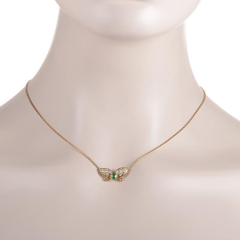 This pendant necklace from Van cleef & Arpels has a whimsical design that sparkles with a rare beauty. The necklace is made of 18K yellow gold and features a petite butterfly-shaped pendant accented with a body made of an ~.30ct emerald and