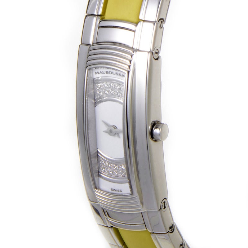 Mauboussin lady's stainless quartz bangle watch with a 20 diamond-set bezel. Watch indicates hours and minutes on a white dial with no markers.Lastly, the bracelet was made of stainless steel with yellow rubber accents.