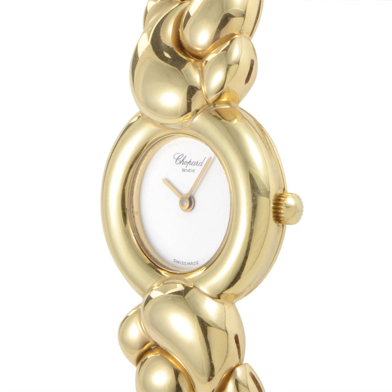 Chopard lady's 18K yellow gold quartz bangle watch. Watch indicates hours and minutes on a mother of pearl dial with no markers.

Included Items:Manufacturer's Box
