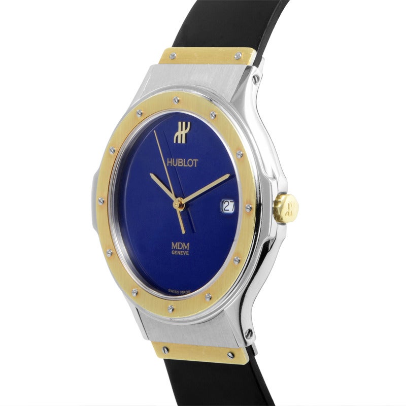 Hublot unisex stainless steel and 18K yellow gold quartz wristwatch on a black rubber strap. Watch indicates hours, minutes, and date on a blue dial.Watch resists water to ~50m/165ft.

Included Items: Manufacturer's Box and Papers
Retail Price: