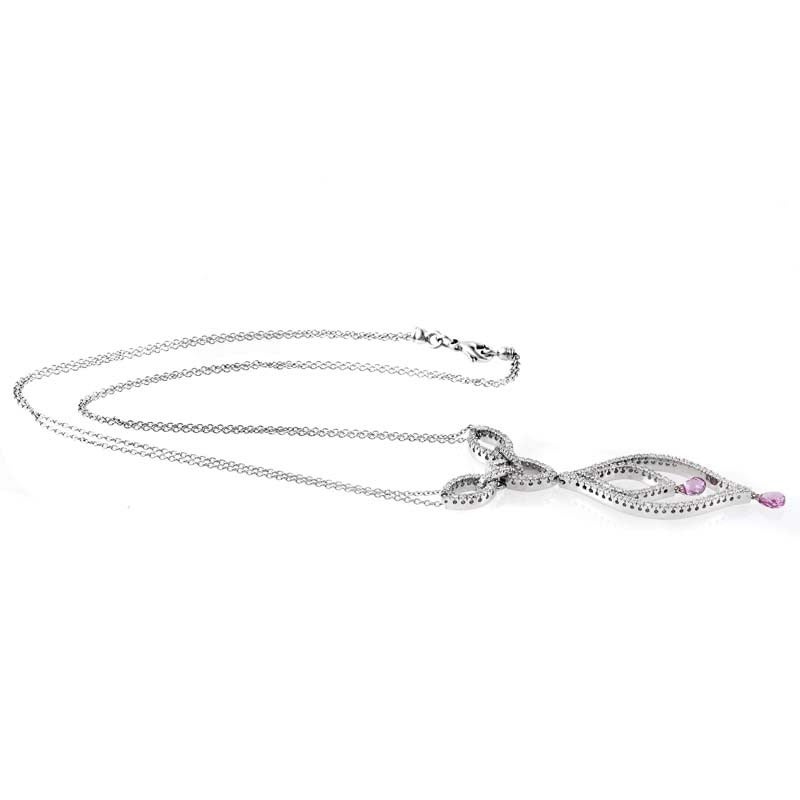 This pendant necklace from Piero Milano has an exceptional design that is absolutely breathtaking. The necklace is made of 18K white gold and features an elaborate pendant set with ~1.04ct of diamonds. Lastly, two faceted pink sapphire beads dangle