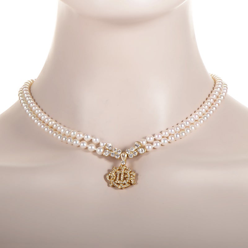 This finely crafted necklace from Christian Dior has a classic look from times long past. Boasting a two-strand pearl necklace and an 18K yellow gold logo pendant completely set with ~4.50ct of diamonds, this necklace is an instant