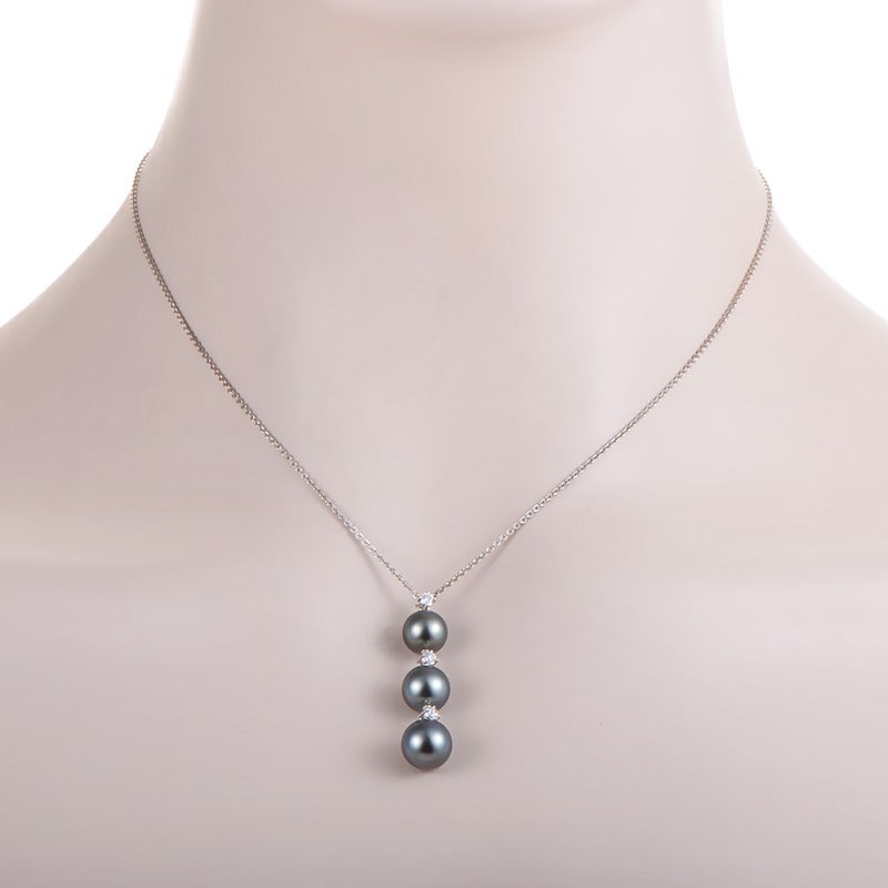Simple and elegant Mikimoto design boasting a gorgeous subtle chain made of 18K white gold, onto which three black pearls and three diamonds hang.

Approximate Dimensions: Drop of the Necklace: 9.50