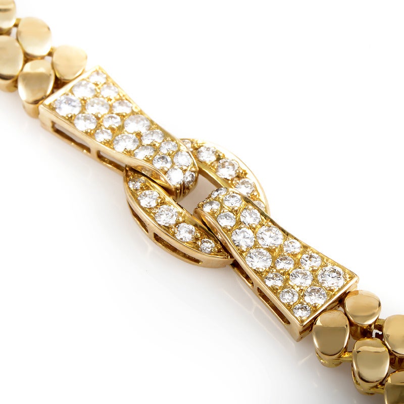 An impressionable jewelry piece by Van Cleef & Arpels made of 18K yellow gold set with approximately two carats of diamonds, with the impressively crafted bracelet slightly resembling rice chain design.

Diamond Carat Weight: 2.00